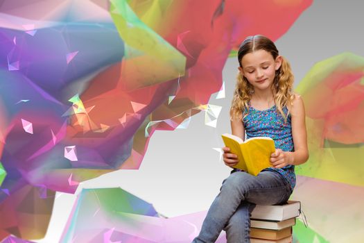 Cute little girl reading book in library against colourful abstract design