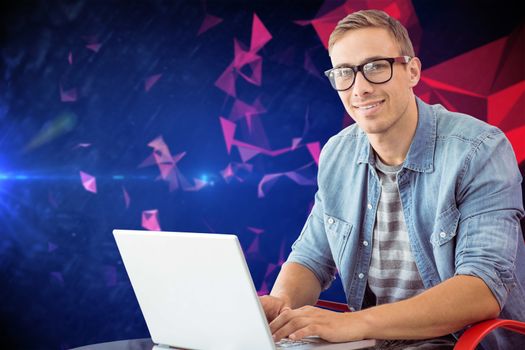 Hipster on laptop against dark abstract design