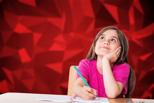 Cute pupil working at her desk against red abstract design