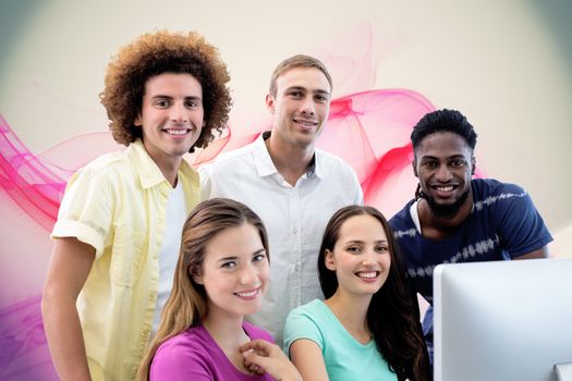 Smiling students in computer class against pink abstract design