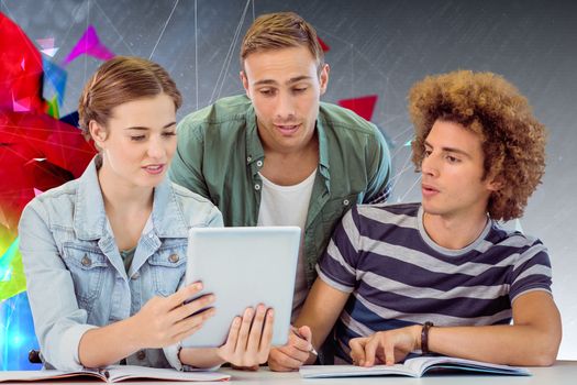 Fashion students using tablet  against geometric design