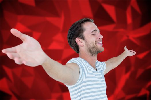 Smiling man standing arms outstretched against red abstract design