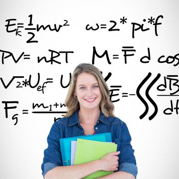 Smiling student holding notebook and file  against maths equation