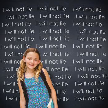 Cute little girl holding book in library against black background