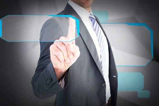 Businessman pointing with his finger against abstract grey room