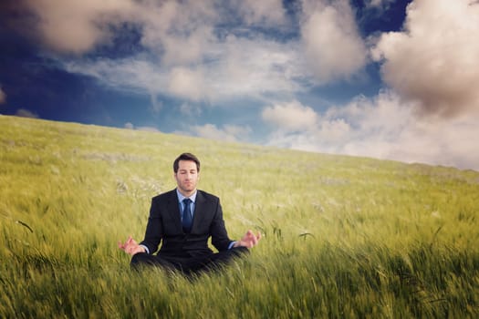 Calm businessman sitting in lotus pose against nature scene