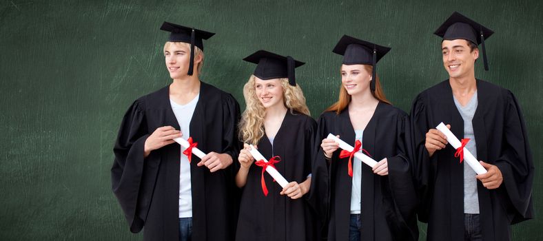 Group of people celebrating after Graduation against green chalkboard