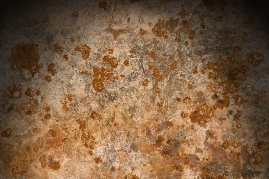 Metallic background with rusty corrosion lit from above