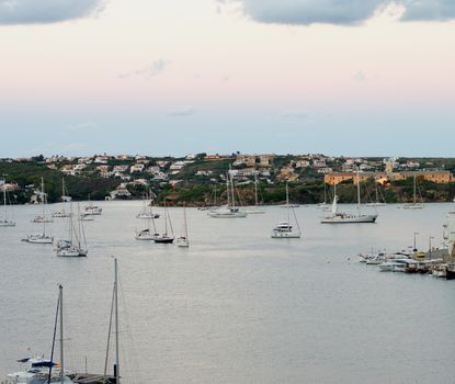 Various Anchor Yachts and Beautiful Sundown in Marina Harbor, Mahon, Menorca, Balearic Islands 