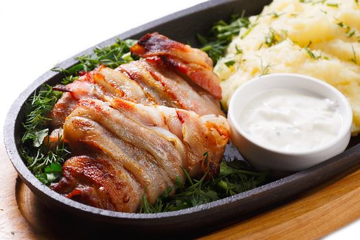 Roasted meat roll with potato puree in a frying pan. Healthy dinner.