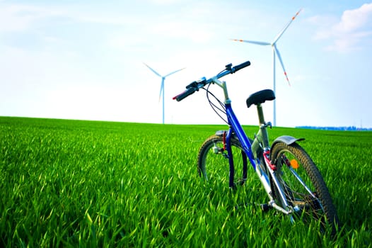 Sport and nature at summer. Bike on the green field with grass at summer.