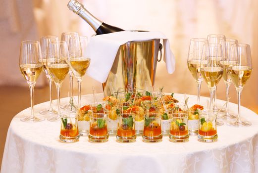Festive table served with appetizers and champagne in glasses. Celebration, wedding,feast concept