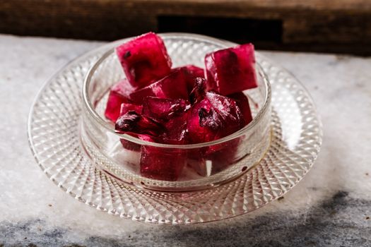 Frozen hibiscus tea also known as karkade, agua fresca or red sorrel on a marble plate