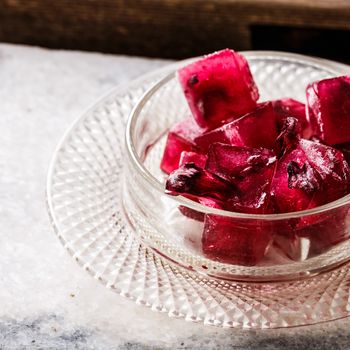 Frozen hibiscus tea also known as karkade, agua fresca or red sorrel on a marble plate