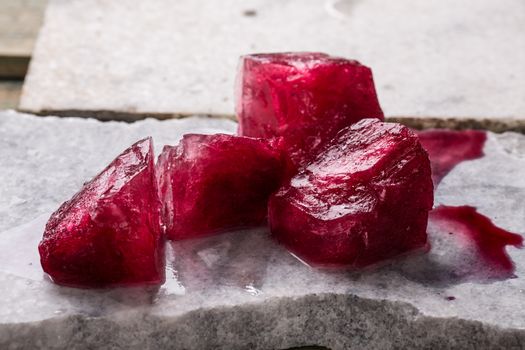 Frozen hibiscus tea also known as karkade, agua fresca or red sorrel on a marble plate