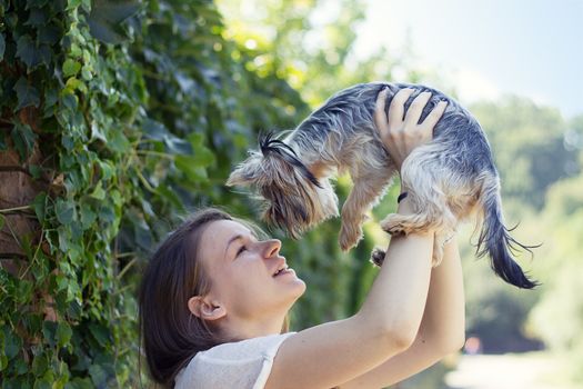 Beautiful woman to kiss the dog Yorkshire terrier