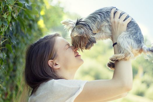 Beautiful woman to kiss the dog Yorkshire terrier