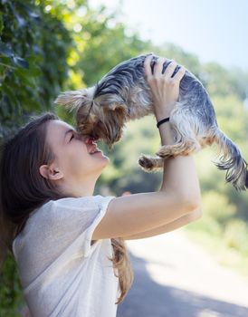Beautiful woman to kiss the dog Yorkshire terrier