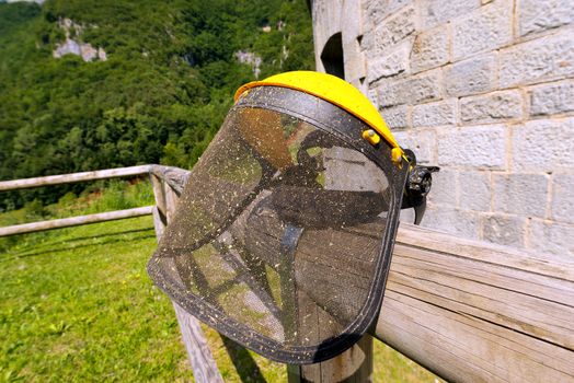 Yellow and black protective mask for for works of gardening, mowing grass. 