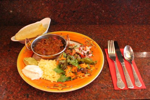 three beef tacos with cheese, lettuce and tomatoes







Beef tacos