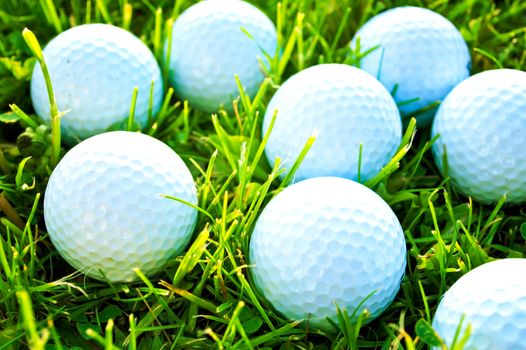 Golf game. Golf balls in grass.