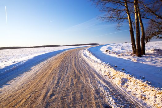 a small road in winter .  landscape