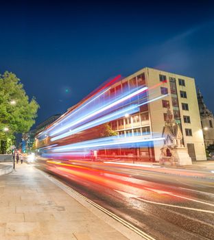 Double Decker bus light trails in London streets.