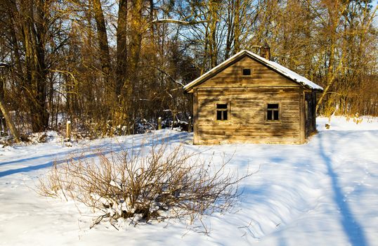a wooden building covered with snow in the winter time