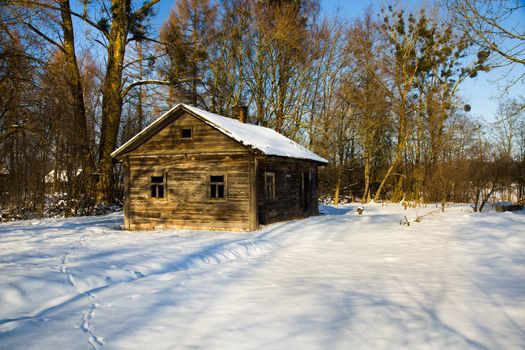 a wooden building covered with snow in the winter time