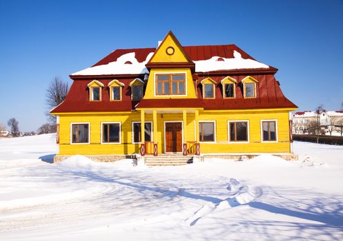 a wooden building covered with snow in the winter time