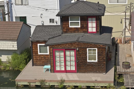 Small floating house with a red door in a bayou Portland Oregon.