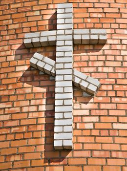 Orthodox cross, laid out of colored bricks