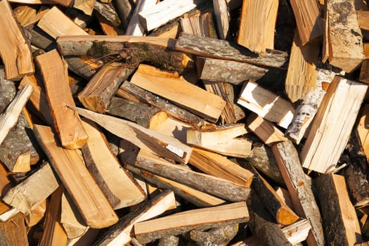   the combined together cut-down and split firewood. a background from firewood