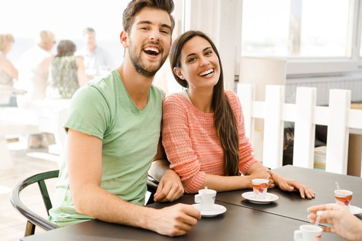 Youg couple at the local coffee shop drinking a coffee