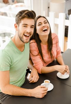 Youg couple at the local coffee shop drinking a coffee