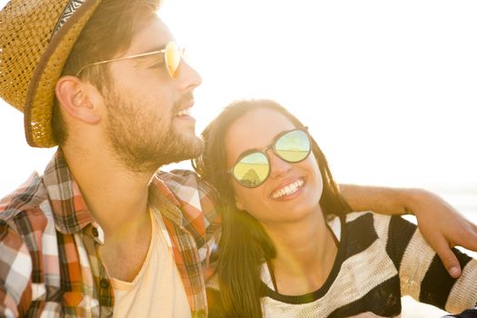 Young couple at the beach and having fun