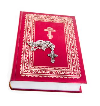 Red Bible with lying on her neck a silver cross