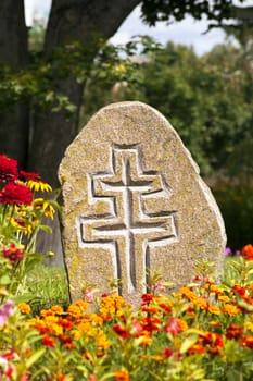   a stone with a cross, used as a monument.