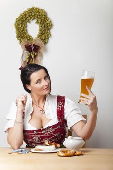 bavarian woman in a dirndl with sausages