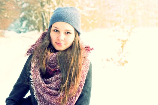 Winter outside portrait of pretty teenage girl dressed in winter clothing. Winter conceptual image. 