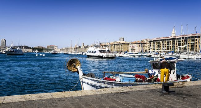 MARSEILLE - AUGUST 19 :Fishermans on a traditional boat at the famous old port on August 19 2015 in Marseille,France.Marseille is France's largest city on the Mediterranean coast and largest commercial port.
