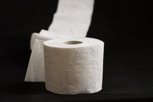 white toilet paper, photographed on a dark background