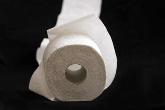 white toilet paper, photographed on a dark background