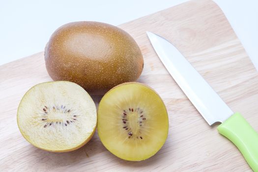 Kiwi on wooden chopping block.