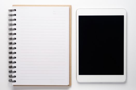 Notebook and tablet on white background.