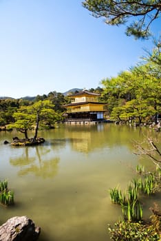 Kinkakuji (Golden Pavilion) is a Zen temple in northern Kyoto whose top two floors are completely covered in gold leaf.