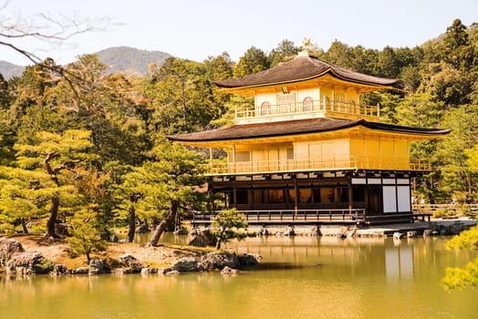 Kinkakuji (Golden Pavilion) is a Zen temple in northern Kyoto whose top two floors are completely covered in gold leaf.