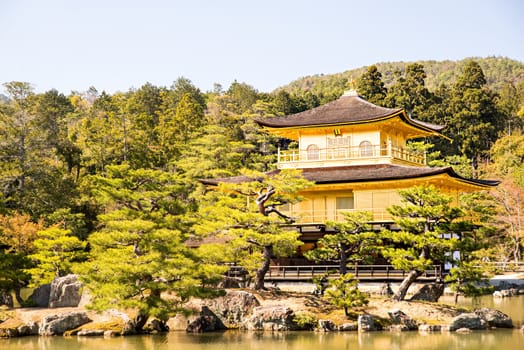 Kinkakuji (Golden Pavilion) is a Zen temple in northern Kyoto whose top two floors are completely covered in gold leaf.