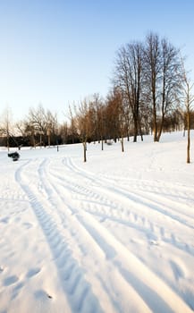   the highway in a winter season. the road is covered with snow