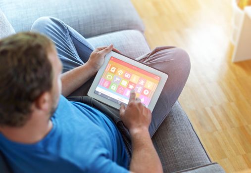 smart house, home automation, device with app icons. Man uses his tablet PC with smarthome app to control his house. the new generation of the internet of things.